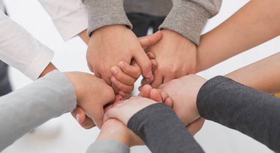 children-with-their-hands-together